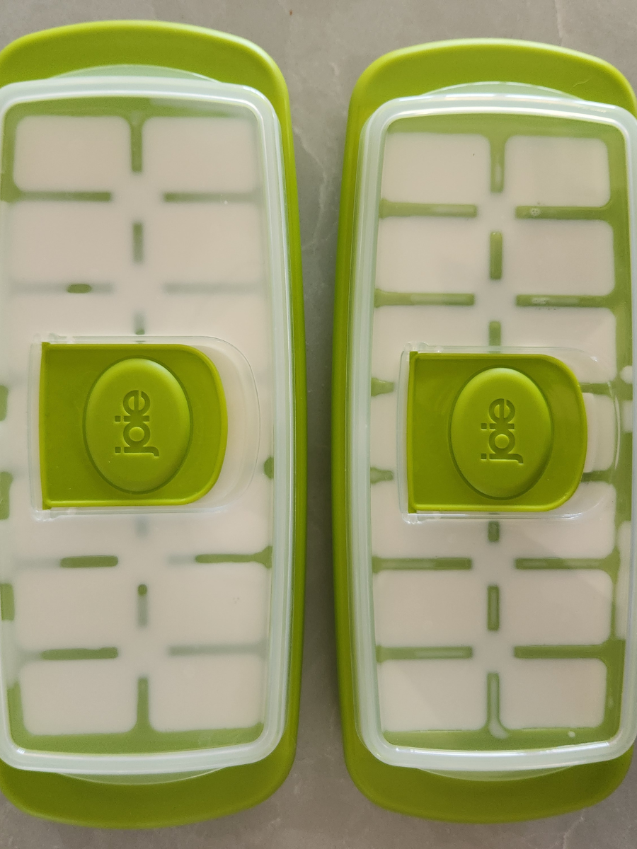 Ice cube trays with lids filled with goat milk before freezing