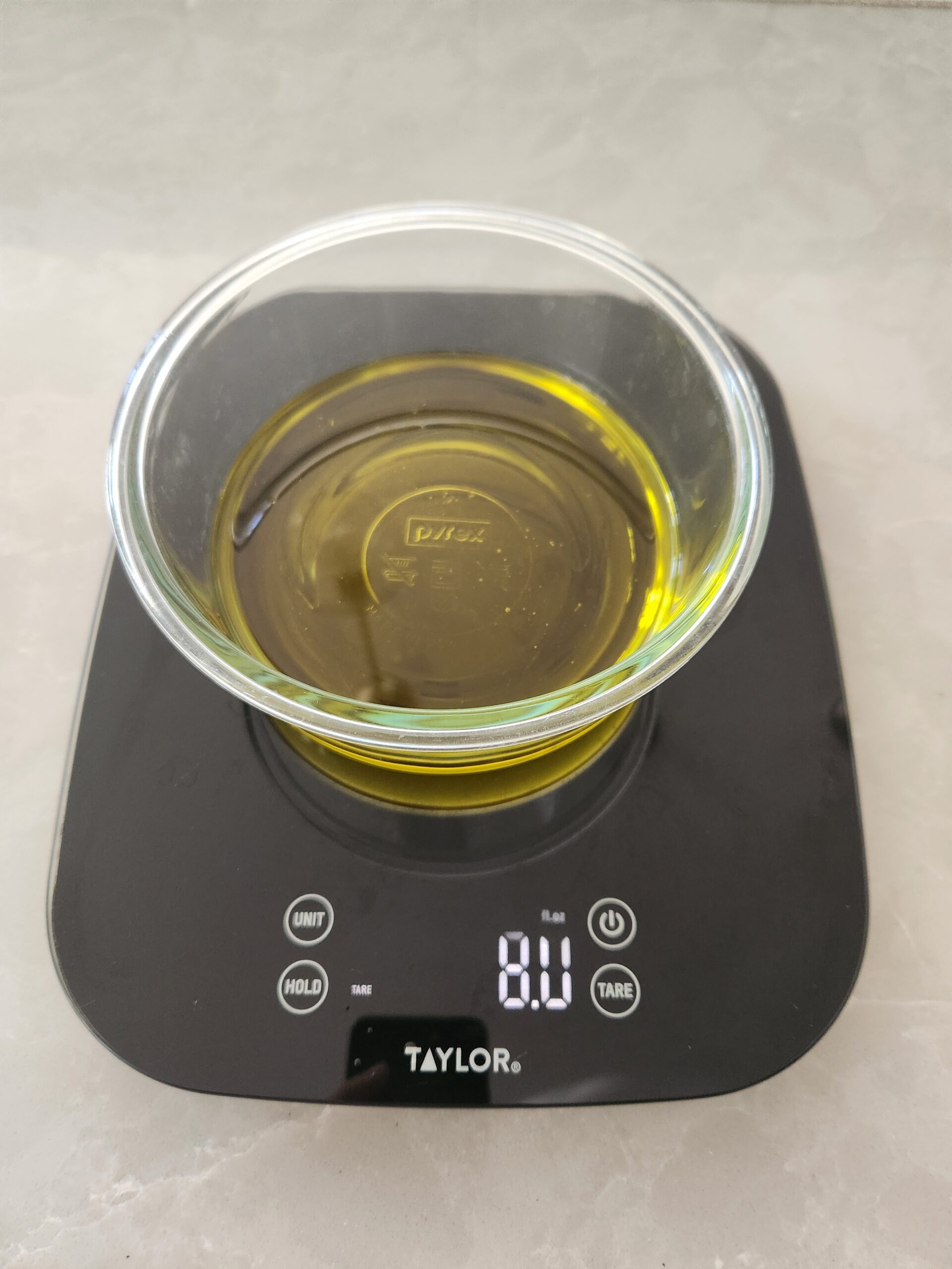 weighing oil for salve on kitchen scale
