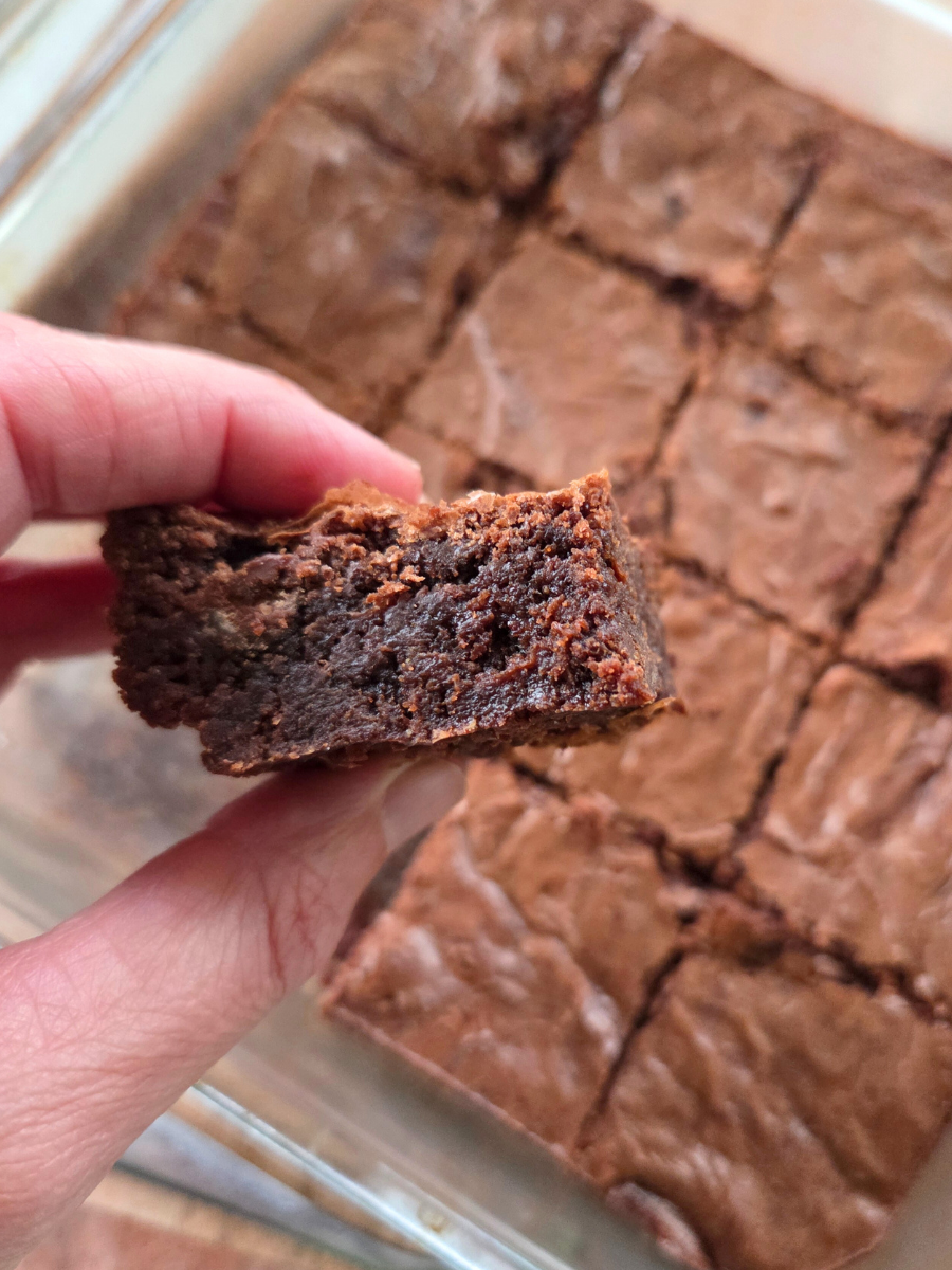 Close-up of the inside of a fresh-milled flour brownie, showing the dense, fudgy texture and rich chocolate color.