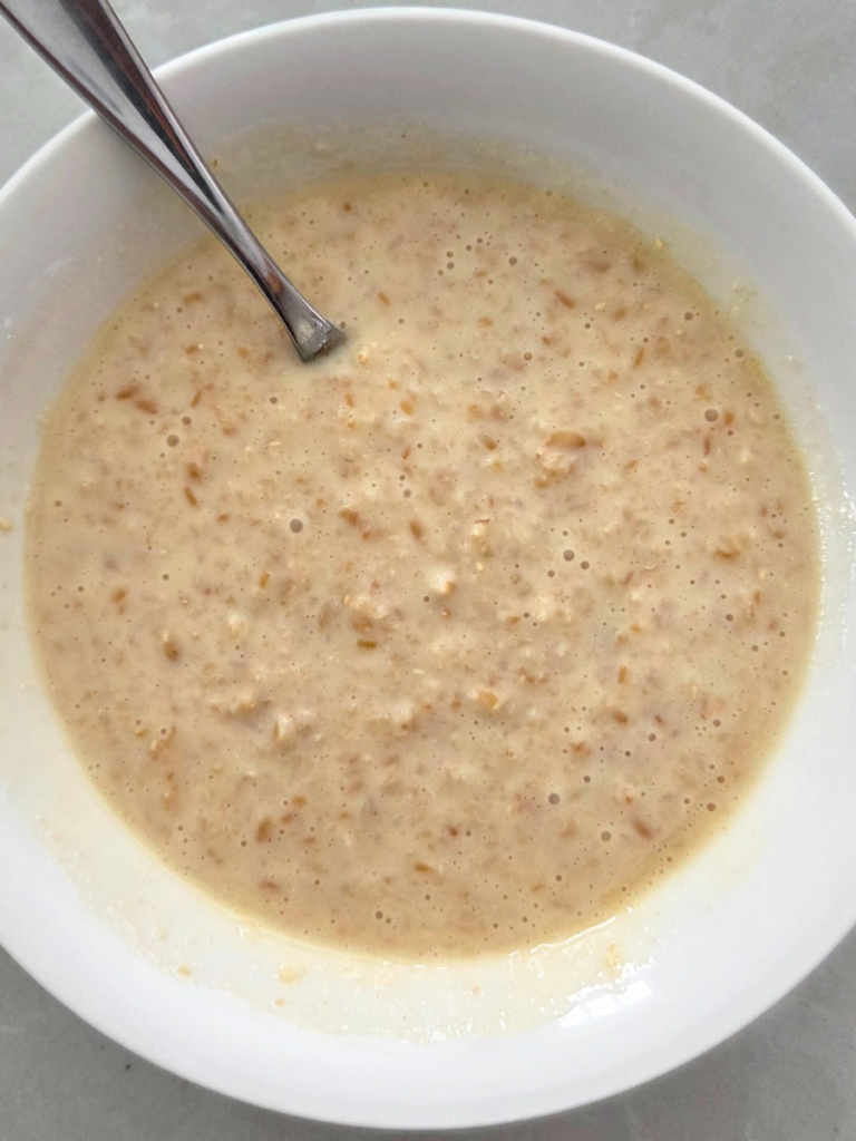 Close-up of freshly prepared fresh milled einkorn cream of wheat in a white bowl on a light countertop.