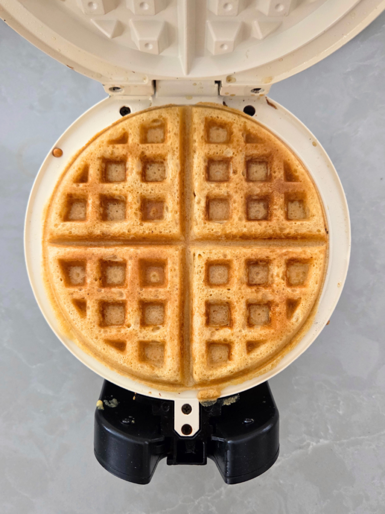 Golden fresh milled flour waffle fully cooked in waffle iron