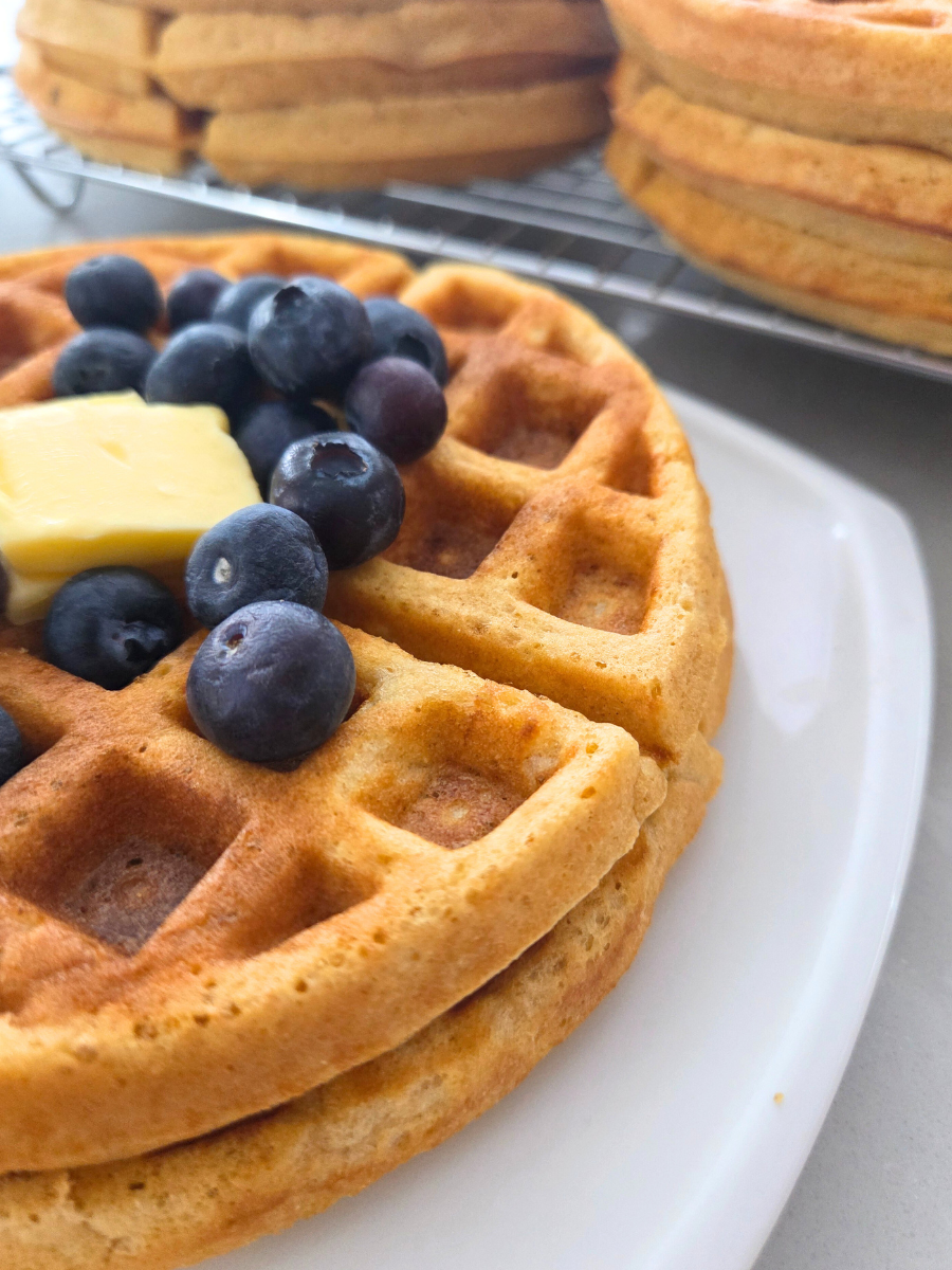 Close-up of golden fresh milled flour waffles showing crisp edges and soft interior