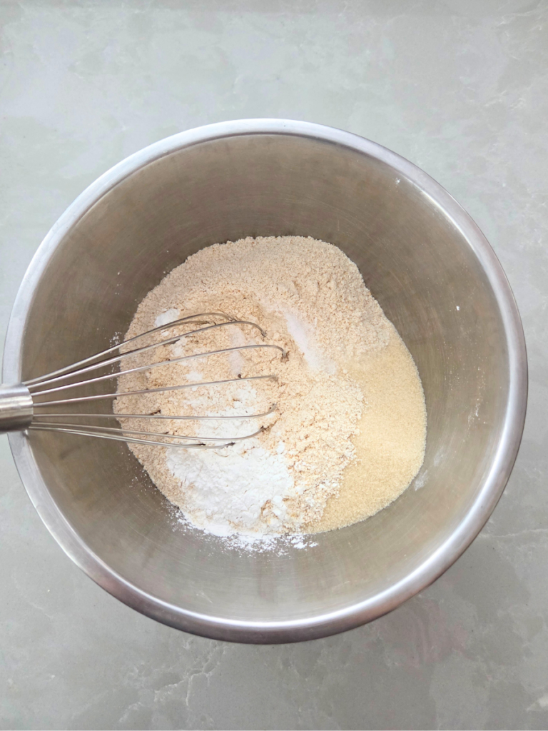 Dry ingredients for fresh milled flour waffles mixed in a stainless steel bowl