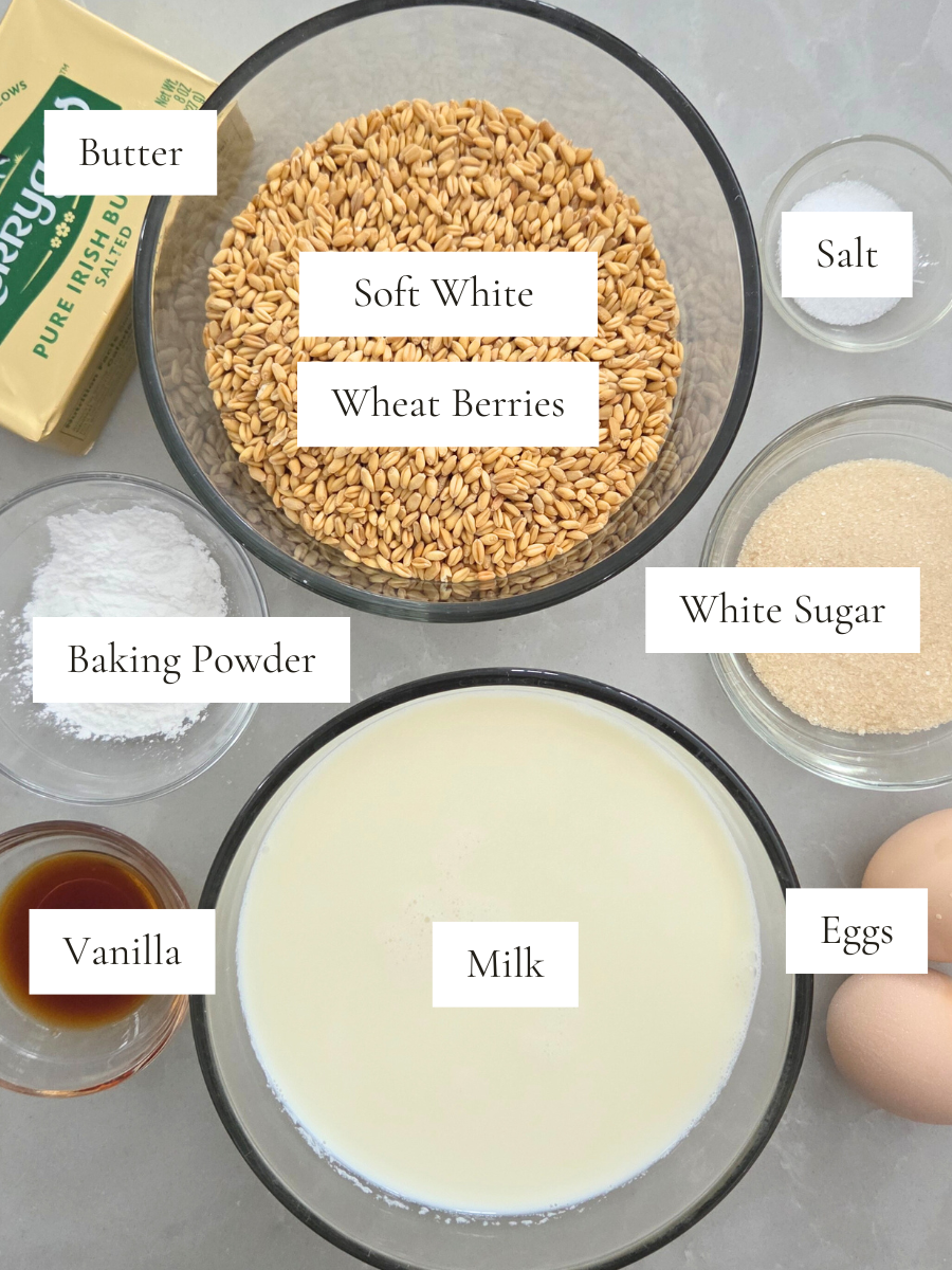 Ingredients for fresh milled flour waffles including soft white wheat berries, milk, eggs, butter, sugar, baking powder, salt, and vanilla