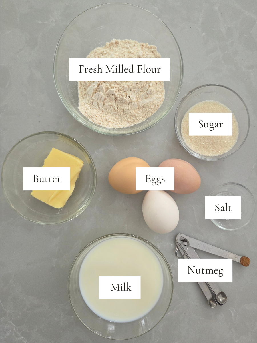 Ingredients for fresh milled flour Dutch baby pancake including flour, eggs, milk, butter, sugar, salt, and nutmeg