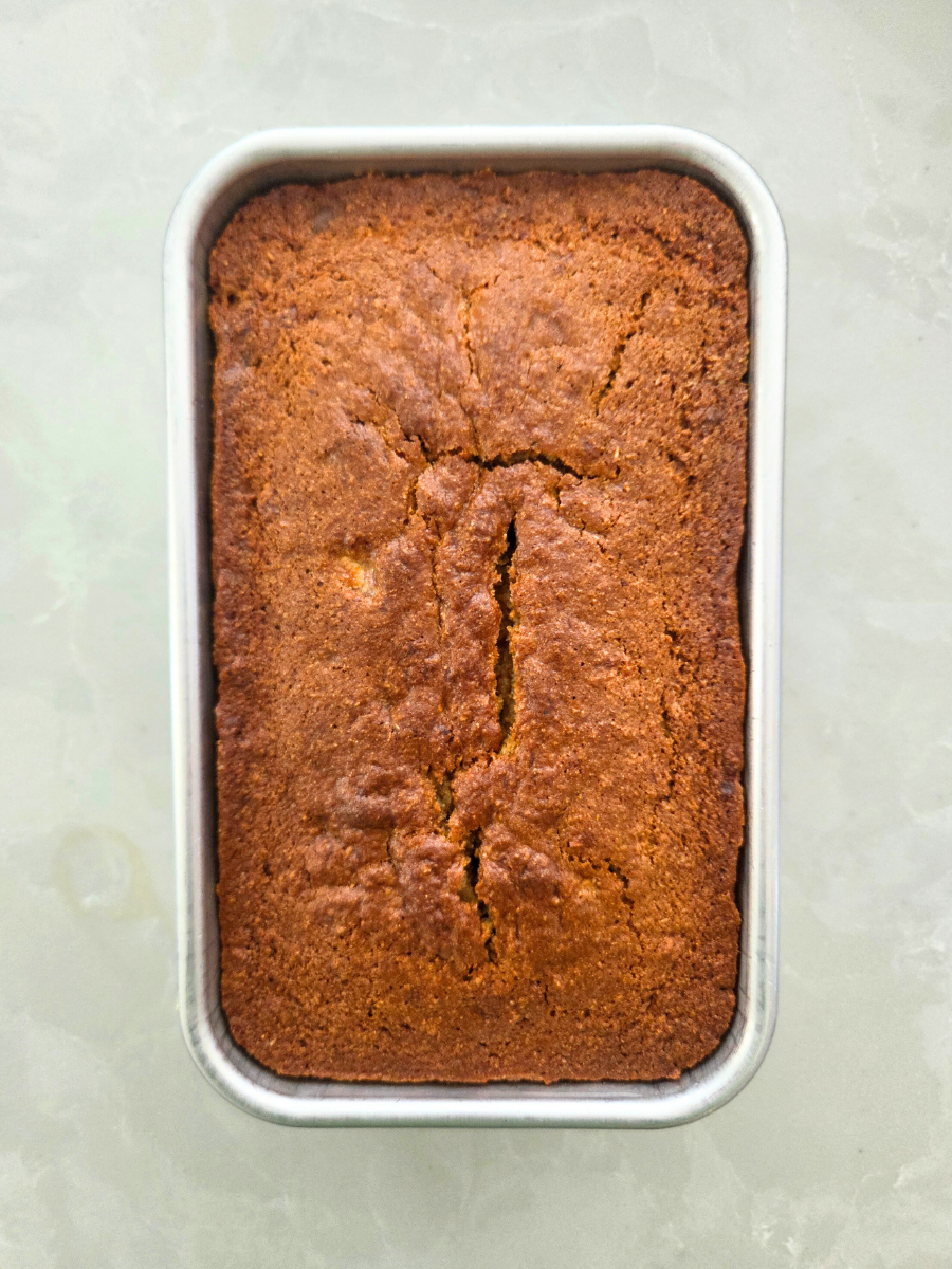 Fresh milled flour banana bread baked in a loaf pan with a golden brown crust.
