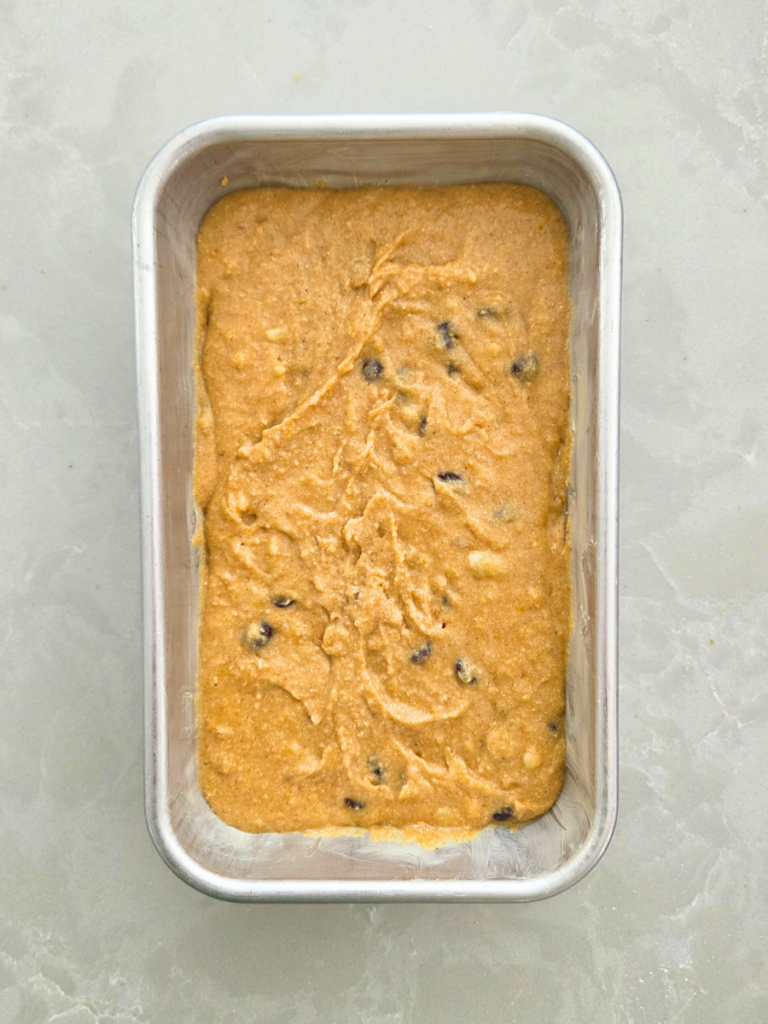 Banana bread batter poured into a loaf pan ready to bake.