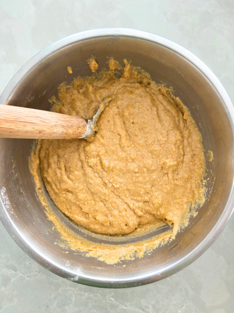 Fresh milled banana bread batter mixed in a bowl.