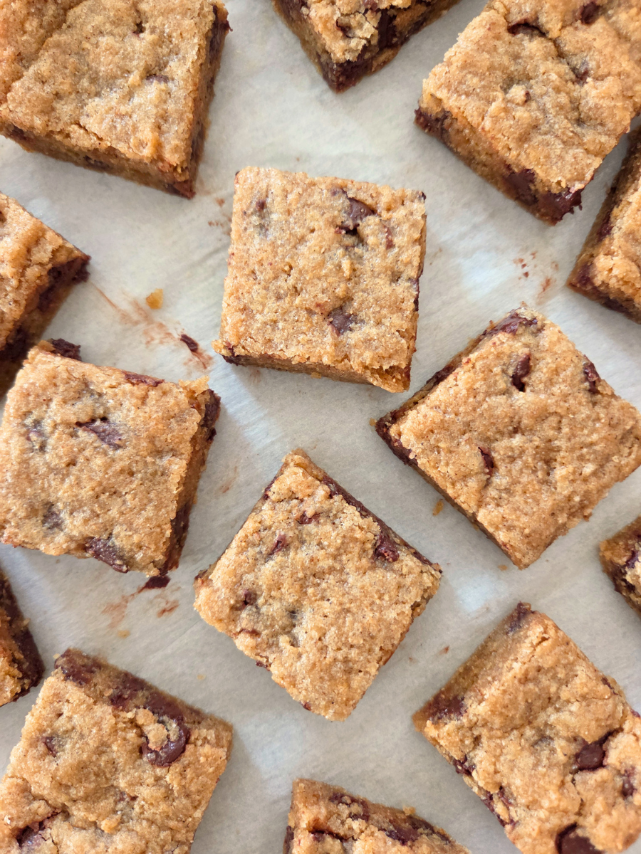 Fresh milled flour banana bread blondies cut into squares on parchment paper