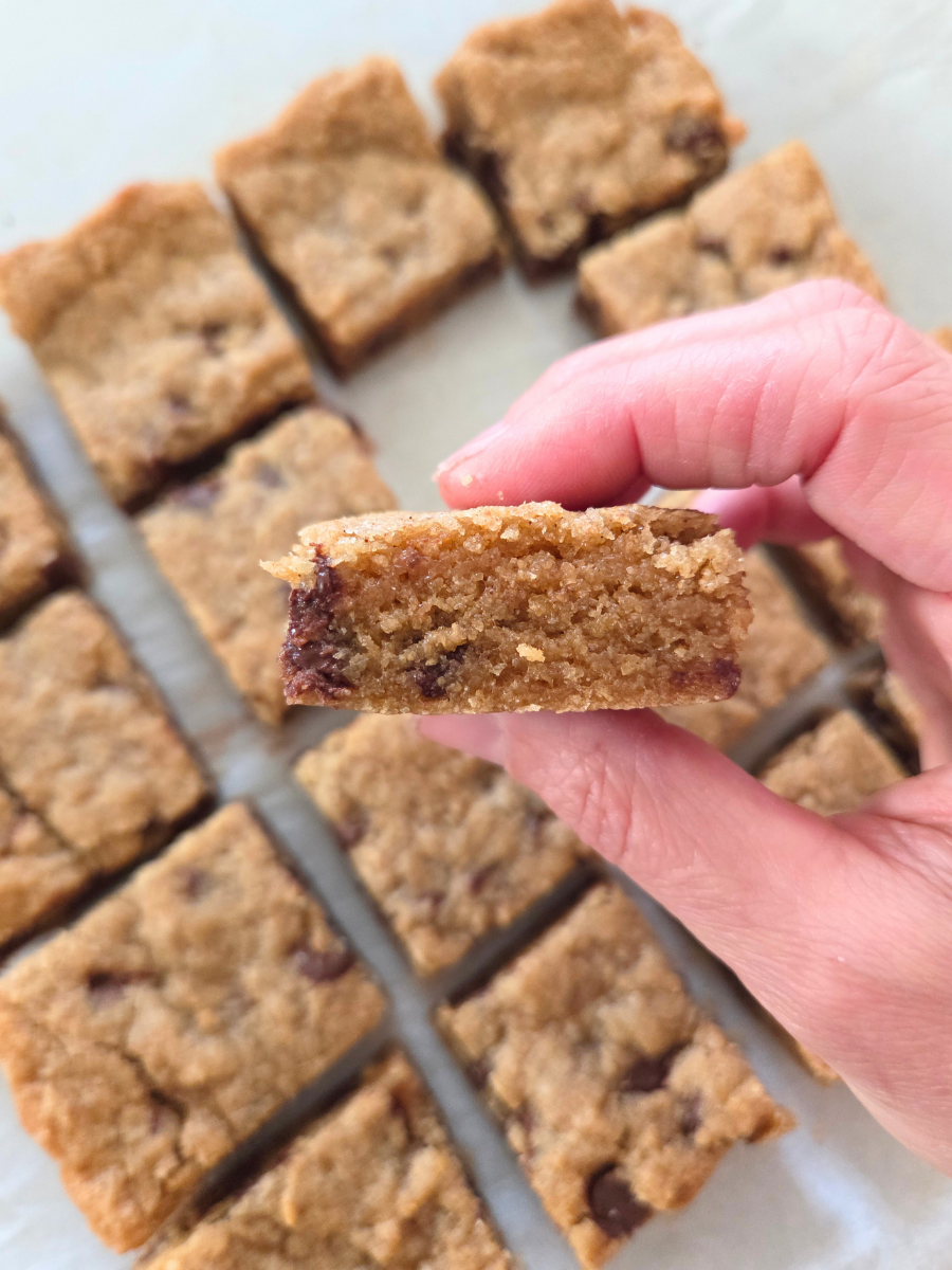 Soft and tender banana blondie made with fresh milled flour showing moist crumb and chocolate chips