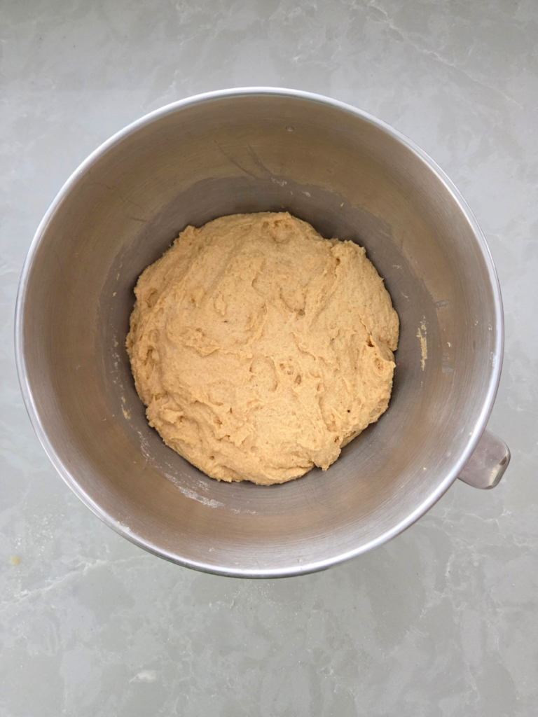 Soft fresh milled dough beginning to come together during kneading.