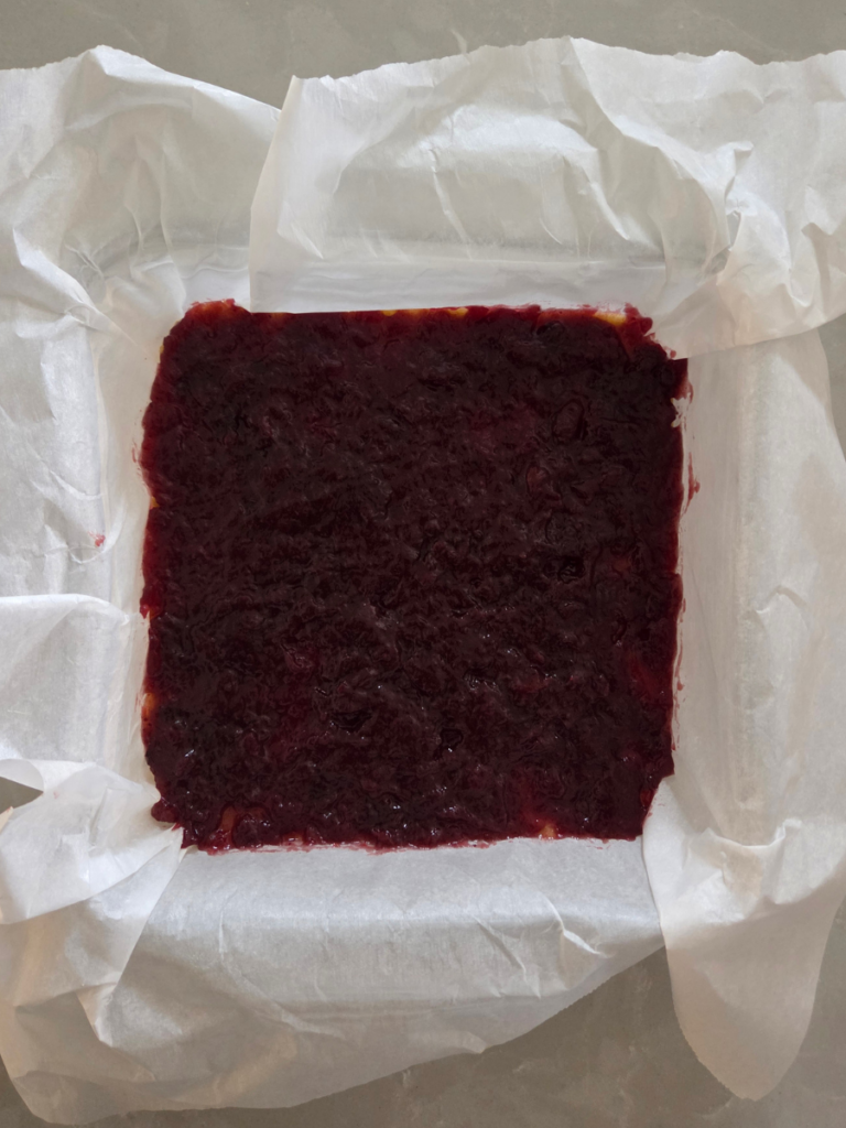 Jam spread evenly over fresh milled shortbread base