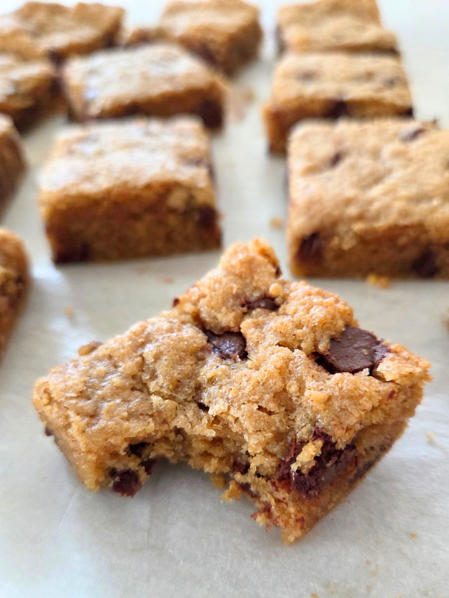 Soft and tender banana bread blondie made with fresh milled flour showing moist crumb and melted chocolate chips