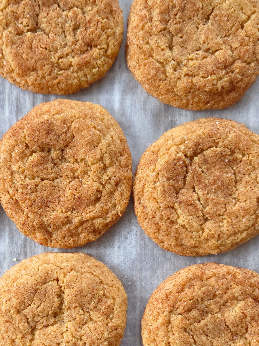 Overhead photo of fresh milled flour snickerdoodle cookies with crackled tops and warm cinnamon coating.