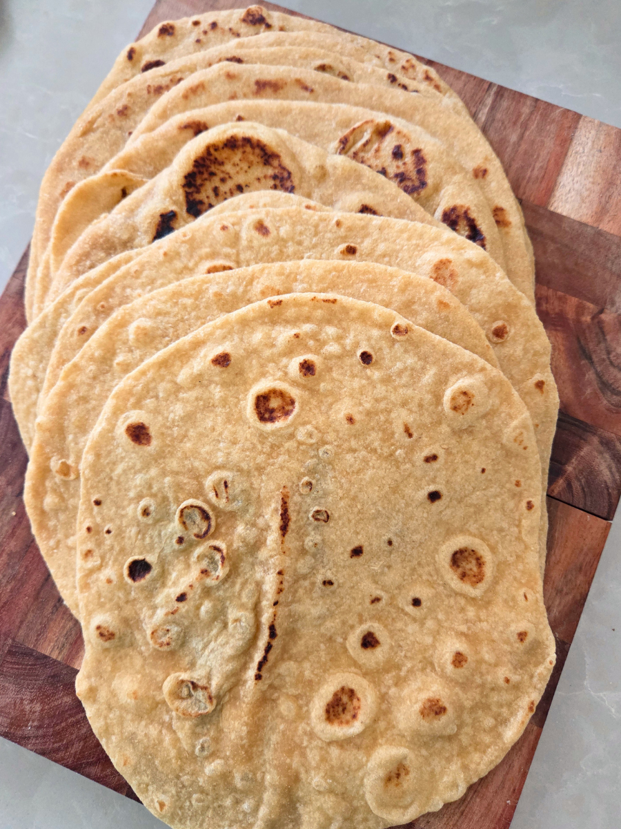 Stack of homemade Fresh Milled Flour Flatbread & Tortillas showing their soft texture and golden brown skillet-cooked spots.