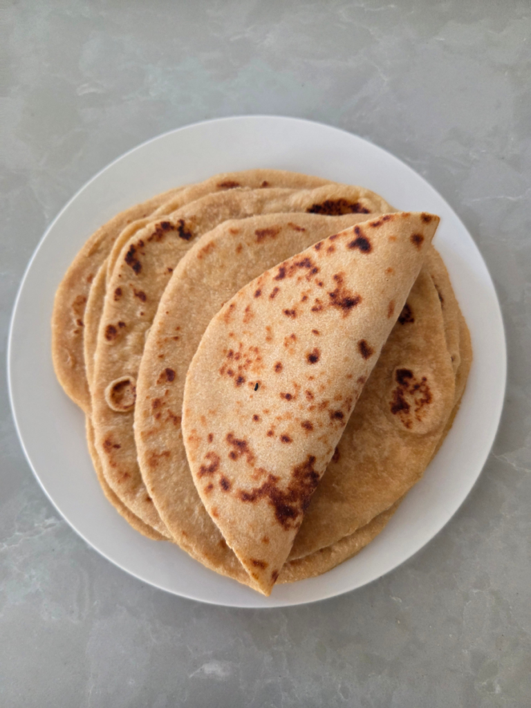 Soft homemade fresh milled flatbread folded to show its tender texture and flexibility.