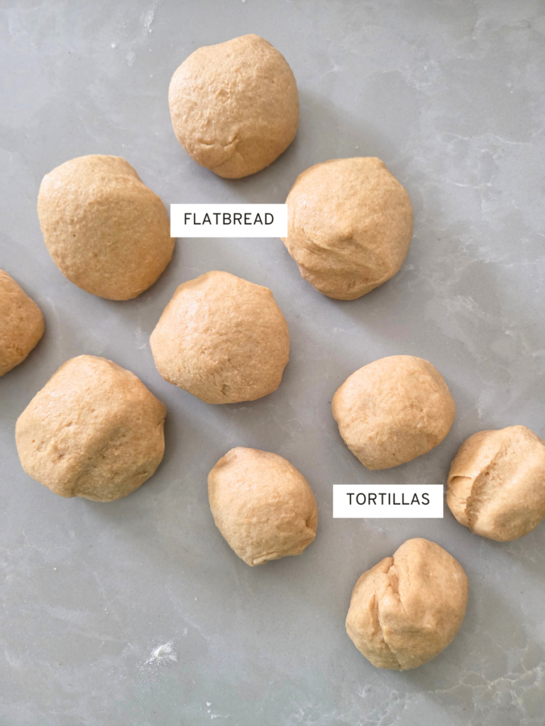 Dough divided into larger portions for flatbread and smaller portions for tortillas.