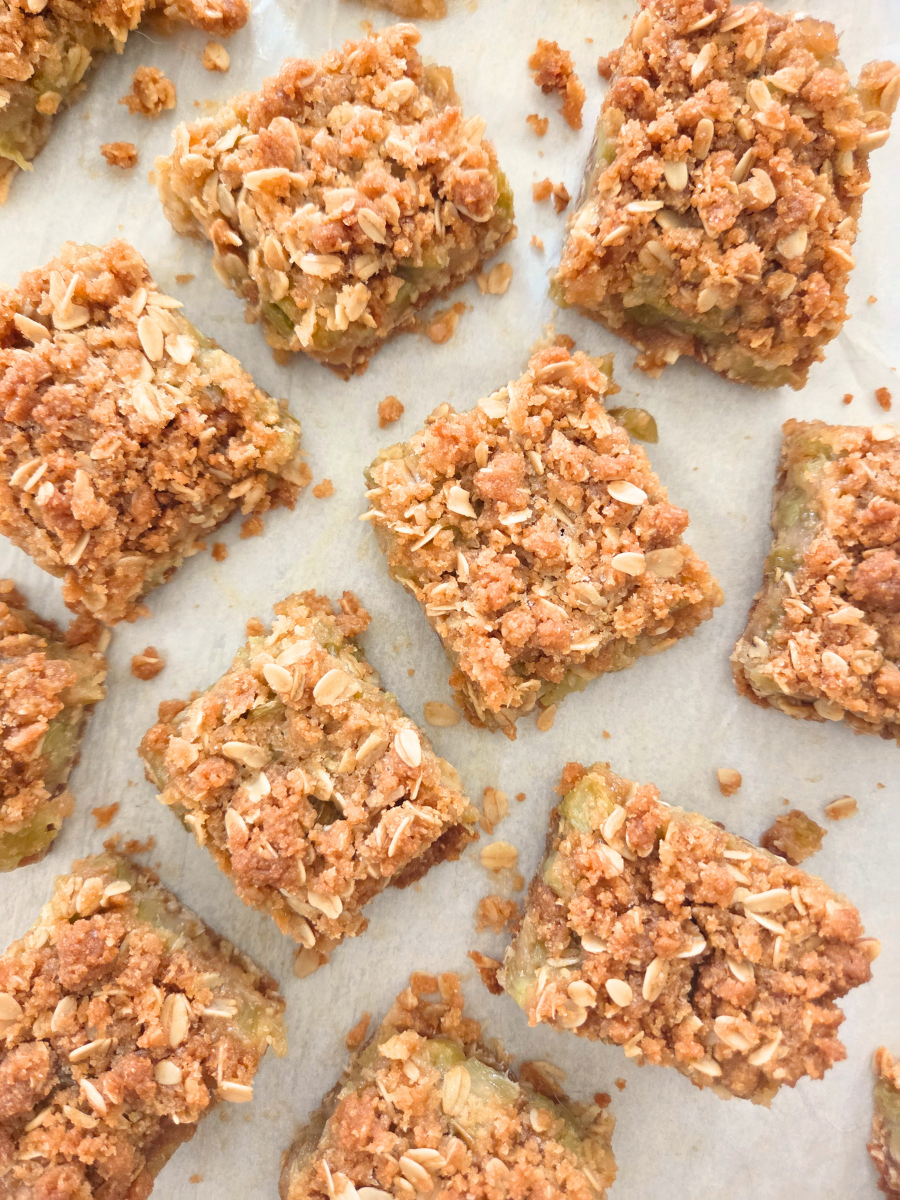 Fresh Milled Flour Rhubarb Crumble Bars arranged on parchment paper with a buttery oat crumble topping.