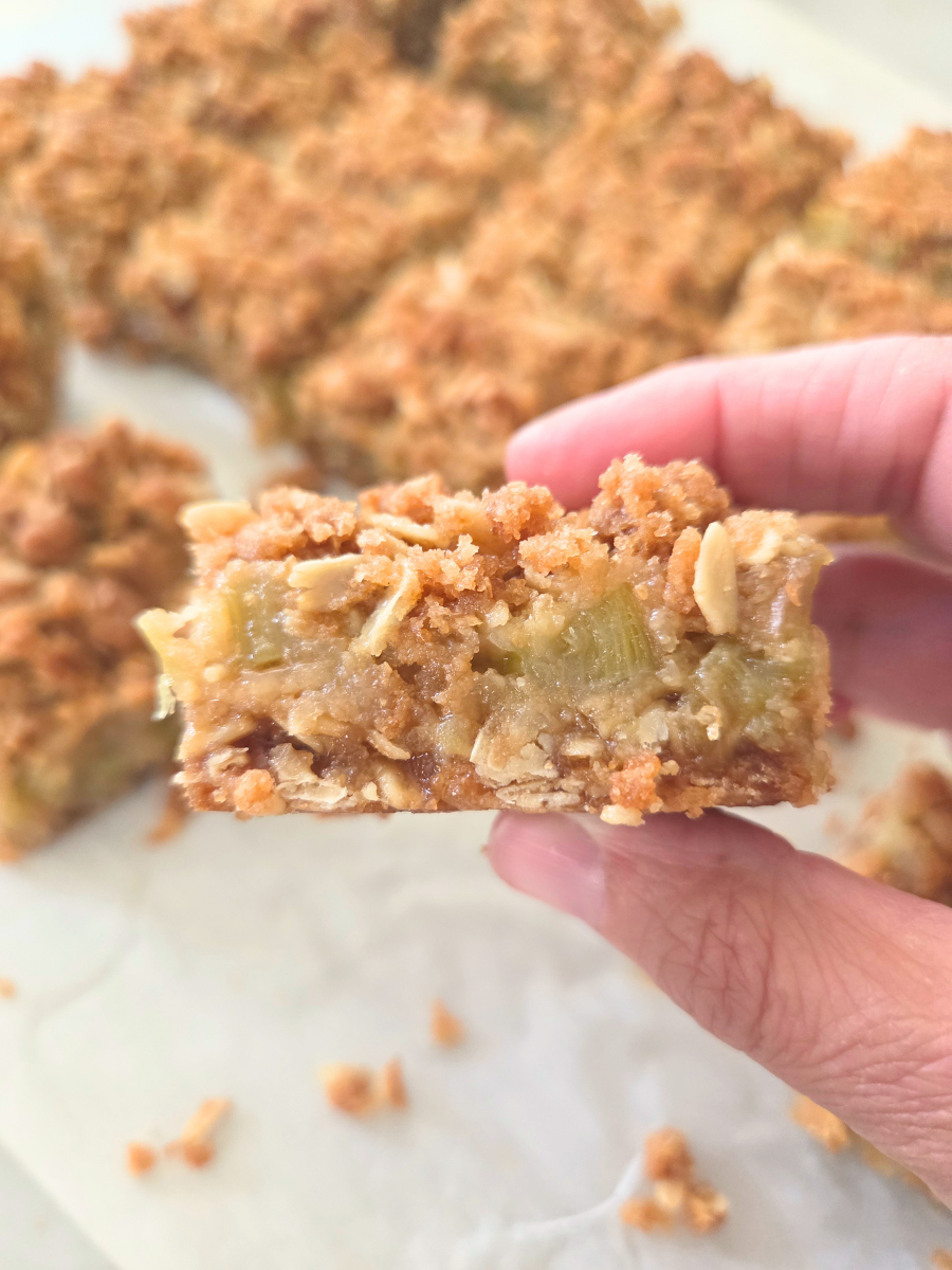 Close-up of a Fresh Milled Flour Rhubarb Crumble Bar showing the buttery crust, tender rhubarb filling, and crisp oat crumble topping.