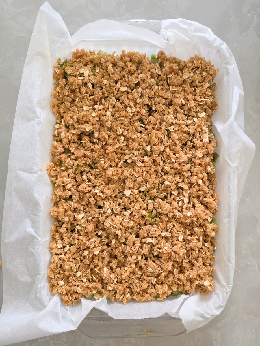 Remaining fresh milled flour oat crumble mixture sprinkled evenly over the rhubarb before baking.