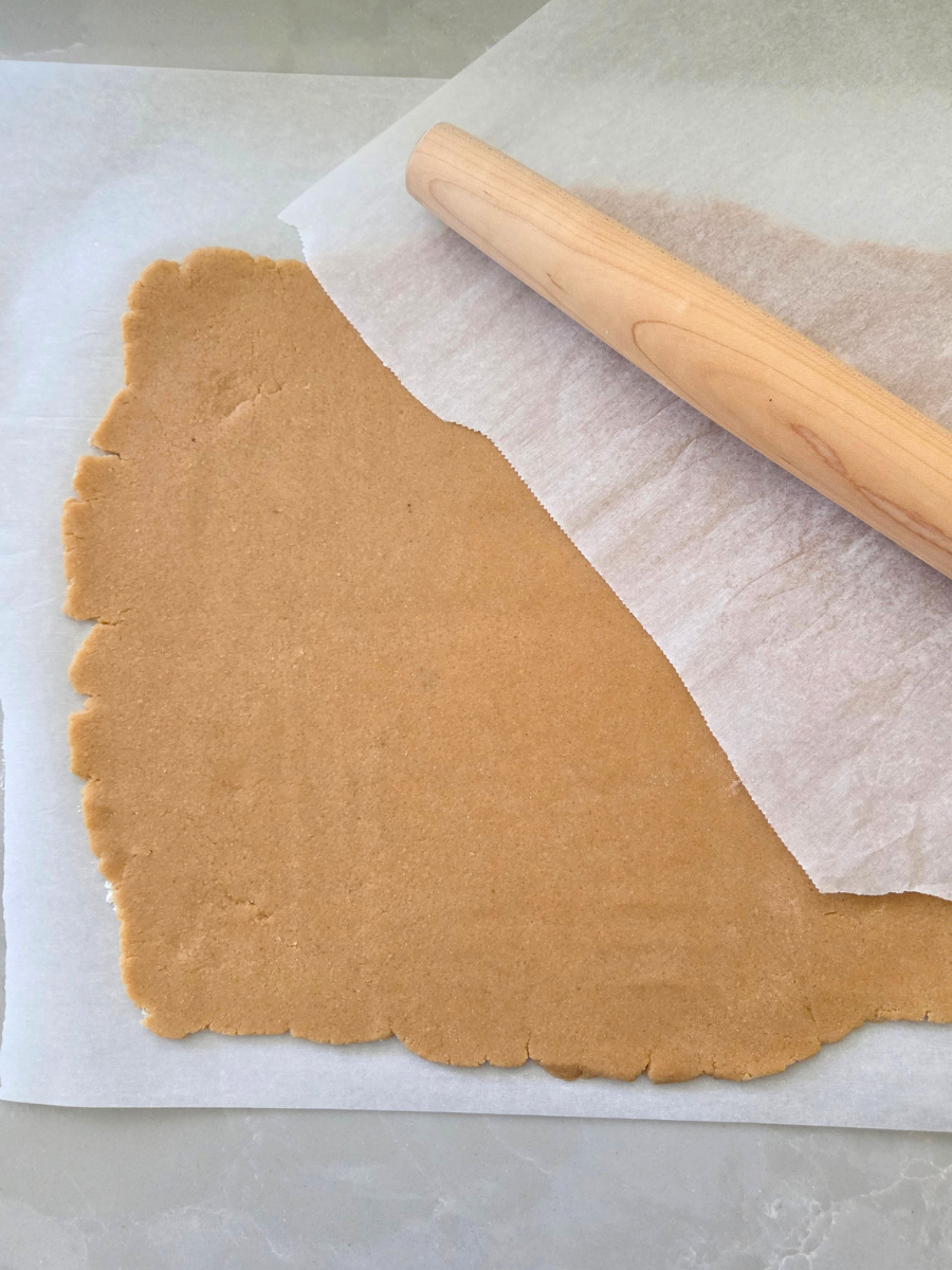 Chilled graham cracker dough rolled thin between sheets of parchment paper