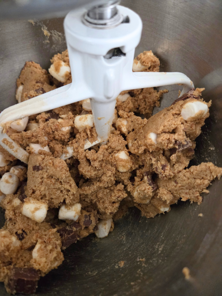 S'mores bar dough with chocolate pieces and mini marshmallows mixed in before baking.