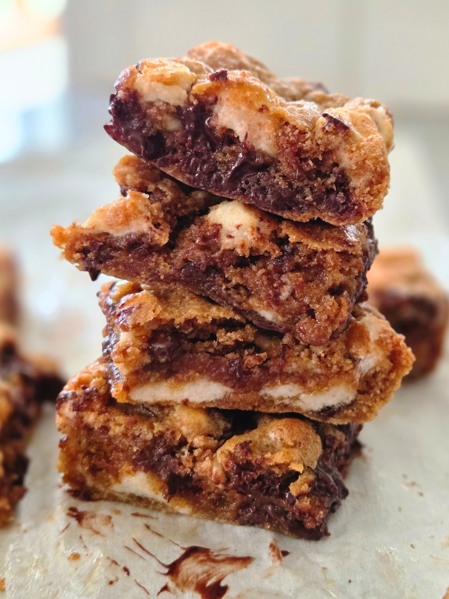 Stack of fresh milled flour s'mores bars with gooey melted chocolate and marshmallows showing the soft chewy center.