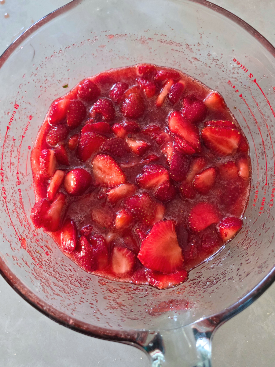 Sliced strawberries mixed with sugar to create a sweet strawberry filling.