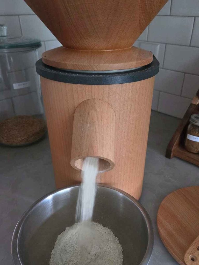 Milling wheat berries into fresh flour for cowboy cookies