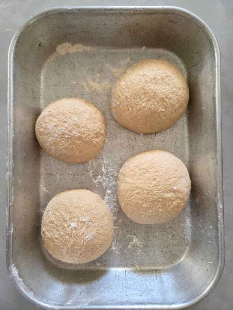 Pizza dough balls in a 9x13 dish before the final rise