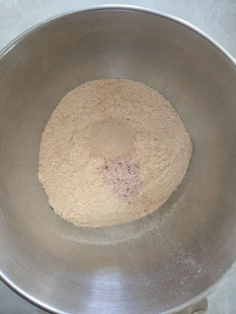 Fresh milled flour, salt, yeast in a bowl to make pizza dough