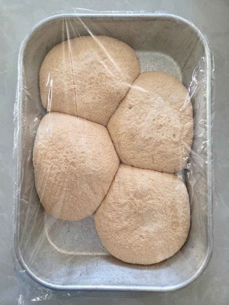 Pizza dough balls in a 9x13 dish after the final rise