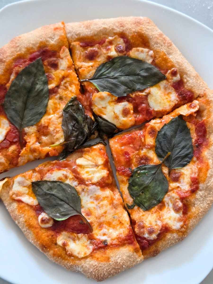 Fresh milled flour pizza dough recipe with a chewy, golden crust, mozzarella, and fresh basil