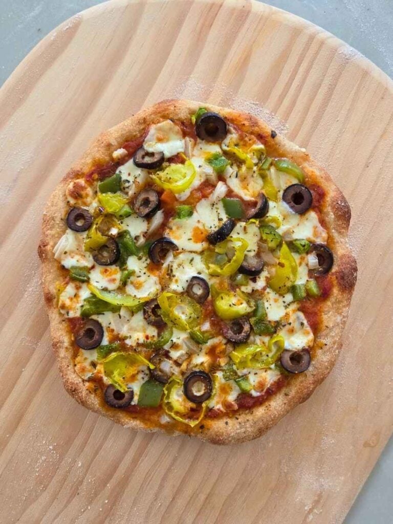 Freshly baked vegetable pizza with a crisp, golden fresh milled flour crust