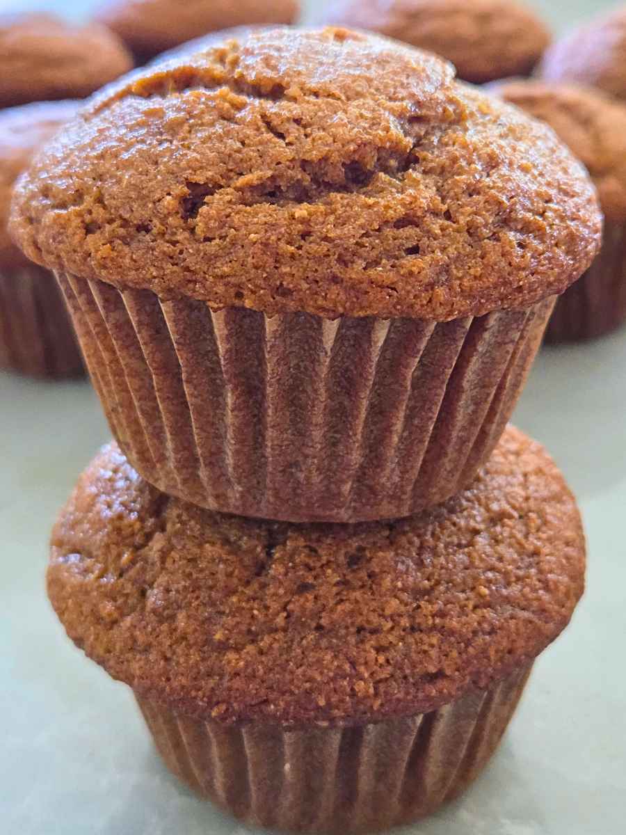 Tall fresh milled flour pumpkin muffins with soft, domed tops.
