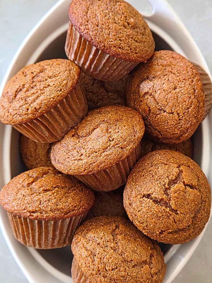 Fresh milled flour pumpkin muffins arranged in a serving bowl.