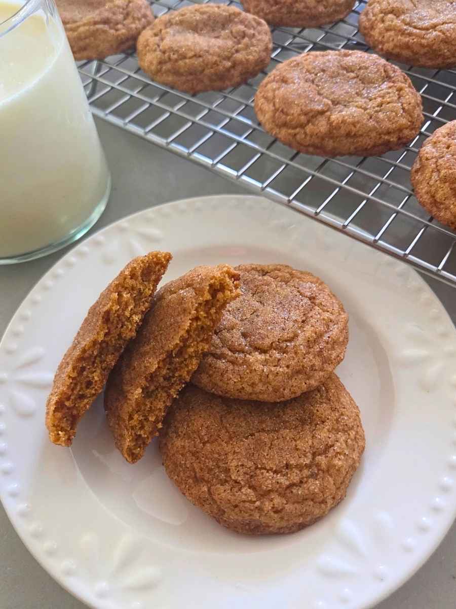 Fresh milled flour pumpkin snickerdoodles with a soft cookie broken open on a plate