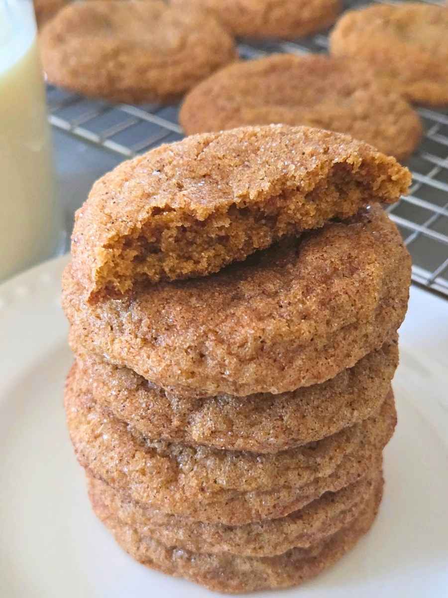 Soft pumpkin snickerdoodle broken open to show the chewy fresh milled flour center